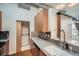 Modern kitchen featuring stainless steel appliances, light wood cabinets, and in-unit washer and dryer at 7700 E 29Th Ave # 404, Denver, CO 80238