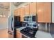 Well-appointed kitchen with stainless steel appliances and light wood cabinets for a bright and airy feel at 7700 E 29Th Ave # 404, Denver, CO 80238