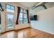 Bright living room features hardwood floors, large windows and modern, industrial style ductwork at 7700 E 29Th Ave # 404, Denver, CO 80238