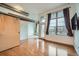 Spacious living room featuring a sliding barn door, hardwood floors, and an abundance of natural light at 7700 E 29Th Ave # 404, Denver, CO 80238