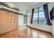 Bright living room featuring sliding barn door, hardwood floors, and an abundance of natural light at 7700 E 29Th Ave # 404, Denver, CO 80238