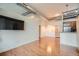 Open concept living room with hardwood floors, modern lighting, and stainless steel appliances at 7700 E 29Th Ave # 404, Denver, CO 80238