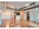 Loft featuring wood floors, open ductwork, sliding door to bathroom, and a modern kitchen at 7700 E 29Th Ave # 404, Denver, CO 80238