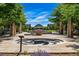 Outdoor public space with stone art installations, landscaping, trees, and pathways under a clear blue sky at 7700 E 29Th Ave # 404, Denver, CO 80238