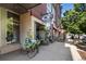 Charming storefront with beautiful floral displays, inviting seating, and brick architectural details at 7700 E 29Th Ave # 404, Denver, CO 80238