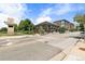 Commercial building on a street corner featuring modern architecture and a welcoming outdoor dining area at 7700 E 29Th Ave # 404, Denver, CO 80238