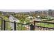 Balcony view overlooking a neighborhood park, a street with parked cars, and apartment buildings at 7700 E 29Th Ave # 404, Denver, CO 80238