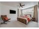 Comfortable bedroom with a wood frame bed, accent chair, and neutral tones, offering a relaxing retreat at 2607 W 24Th Ave, Denver, CO 80211
