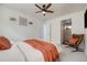Inviting bedroom with stylish decor, including accent chair and a view to an ensuite bathroom at 2607 W 24Th Ave, Denver, CO 80211