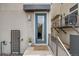 Well-lit entry with a modern door, small patio with stylish steps, and minimalist landscaping at 2607 W 24Th Ave, Denver, CO 80211