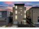 Modern three-story home featuring clean lines, large windows, and a sleek exterior design at 2607 W 24Th Ave, Denver, CO 80211