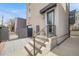 Contemporary home exterior showcasing a landscaped yard and a gated drive leading to the garage at 2607 W 24Th Ave, Denver, CO 80211