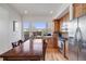 Bright and airy kitchen showcasing stainless steel appliances, wood cabinetry, and access to the outdoor patio at 2607 W 24Th Ave, Denver, CO 80211
