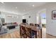 Bright living space featuring a gray sofa, leather ottoman, hardwood floors, and open stairwell at 2607 W 24Th Ave, Denver, CO 80211