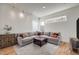 Comfortable living room featuring a gray sectional sofa, neutral rug, and modern track lighting at 2607 W 24Th Ave, Denver, CO 80211