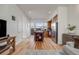 Well-lit living and kitchen area with hardwood floors, modern decor, and access to an outdoor balcony at 2607 W 24Th Ave, Denver, CO 80211