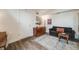 Cozy living room featuring a stylish sofa, wood flooring, and a rustic sideboard for storage at 2607 W 24Th Ave, Denver, CO 80211