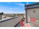 Relaxing rooftop deck with red chairs and table, perfect for enjoying the outdoors and city views at 2607 W 24Th Ave, Denver, CO 80211