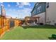 Backyard with a pergola, artificial turf, and a basketball hoop for fun and games at 5687 Dayton St, Denver, CO 80238