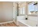 Bright bathroom featuring a shower over tub and modern fixtures at 5687 Dayton St, Denver, CO 80238