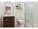 Modern bathroom showcasing a vanity with a dark wood cabinet, white countertop, and a glass-enclosed shower at 5687 Dayton St, Denver, CO 80238