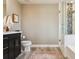 Bathroom with a glass-enclosed shower, dark wood vanity, and neutral walls at 5687 Dayton St, Denver, CO 80238