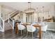 Elegant dining area with modern chandelier and stairs leading to the second floor in the background at 5687 Dayton St, Denver, CO 80238