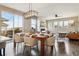 Open dining area with a wooden table, stylish light fixture, and sliding glass door to the outdoor space at 5687 Dayton St, Denver, CO 80238