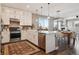 Bright, open kitchen with stainless steel appliances adjoins the dining area and living room at 5687 Dayton St, Denver, CO 80238