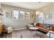 Cozy living room features hardwood floors, lots of natural light, modern decor, and a comfortable leather sofa at 5687 Dayton St, Denver, CO 80238