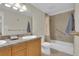 Bathroom with tile tub/shower, large mirror and vanity with lots of storage at 7504 E Jefferson Dr, Denver, CO 80237