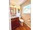 Cozy bathroom with hardwood floors, granite countertops, and updated vanity at 7504 E Jefferson Dr, Denver, CO 80237