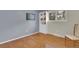 Bedroom features hardwood floors, large windows, and a built-in bookshelf at 7504 E Jefferson Dr, Denver, CO 80237