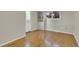 Bedroom featuring hardwood floors, large windows, and a built-in bookshelf by the entry door at 7504 E Jefferson Dr, Denver, CO 80237