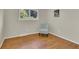 Bedroom featuring wood floors and a large window that provides natural lighting at 7504 E Jefferson Dr, Denver, CO 80237
