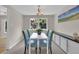 Cozy dining area with modern lighting, seating for four, and a view of the outdoors at 7504 E Jefferson Dr, Denver, CO 80237