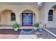 Inviting entryway showcasing double doors with decorative glass, flanked by potted plants at 7504 E Jefferson Dr, Denver, CO 80237