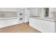 Bright kitchen with white cabinetry, double oven, and stainless steel appliances at 7504 E Jefferson Dr, Denver, CO 80237