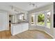 Bright kitchen features a bay window with backyard views and a light-colored countertop island at 7504 E Jefferson Dr, Denver, CO 80237