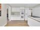 Bright kitchen with white cabinetry, double oven, and stainless steel appliances at 7504 E Jefferson Dr, Denver, CO 80237