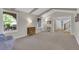 Open living room with plush carpet, neutral walls, and large windows offering ample light at 7504 E Jefferson Dr, Denver, CO 80237