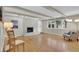 Spacious living room boasts a cozy fireplace, exposed beams, and abundant natural light at 7504 E Jefferson Dr, Denver, CO 80237