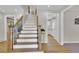 Staircase with combined wood and white painted risers, complemented by decorative wrought iron spindles at 7504 E Jefferson Dr, Denver, CO 80237