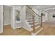 Elegant staircase with wooden treads, wrought iron balusters and a matching wooden handrail at 7504 E Jefferson Dr, Denver, CO 80237