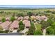 An aerial view shows the neighborhood, including a luxurious house surrounded by lush trees and landscaping at 4775 S Anaheim Ct, Aurora, CO 80015