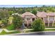 Lush landscaping surrounds this luxury house, complete with balconies and inviting covered porch and patio at 4775 S Anaheim Ct, Aurora, CO 80015