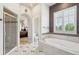 Bright bathroom showcases a soaking tub, glass shower, and plantation shutters at 4775 S Anaheim Ct, Aurora, CO 80015