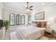 Cozy bedroom with a comfortable bed, stylish decor, and natural light from the arched windows at 4775 S Anaheim Ct, Aurora, CO 80015