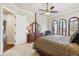 Bright bedroom boasts a plush carpet, ceiling fan and three arched windows at 4775 S Anaheim Ct, Aurora, CO 80015
