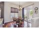 Cozy dining area with natural light, hardwood floors, and access to an outdoor balcony at 4775 S Anaheim Ct, Aurora, CO 80015